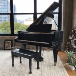 A black Mason & Hamlin grand piano in a loft style apartment.